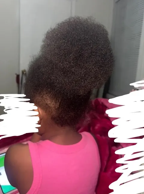 Child after: hair gathered into a much fuller puff