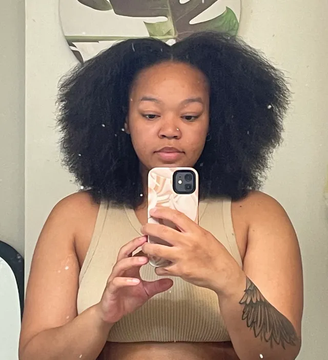 Jasmine before: natural curls sitting at shoulder length
